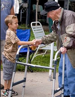 An older adult receiving a helping hand outdoors