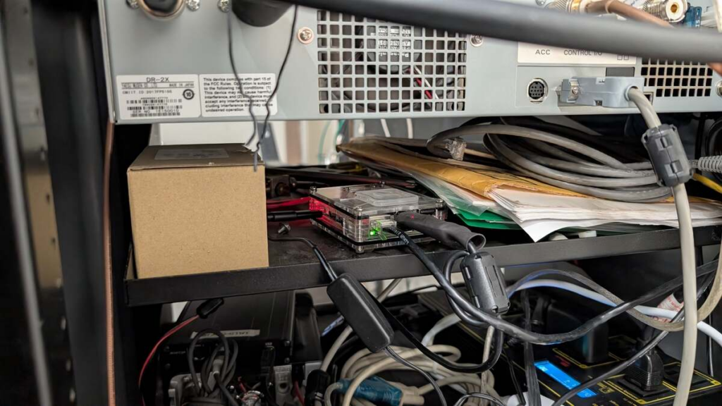 NY7S AllStar Raspberry Pi node in a clear case with Ethernet, USB, and power connections on a rack shelf.