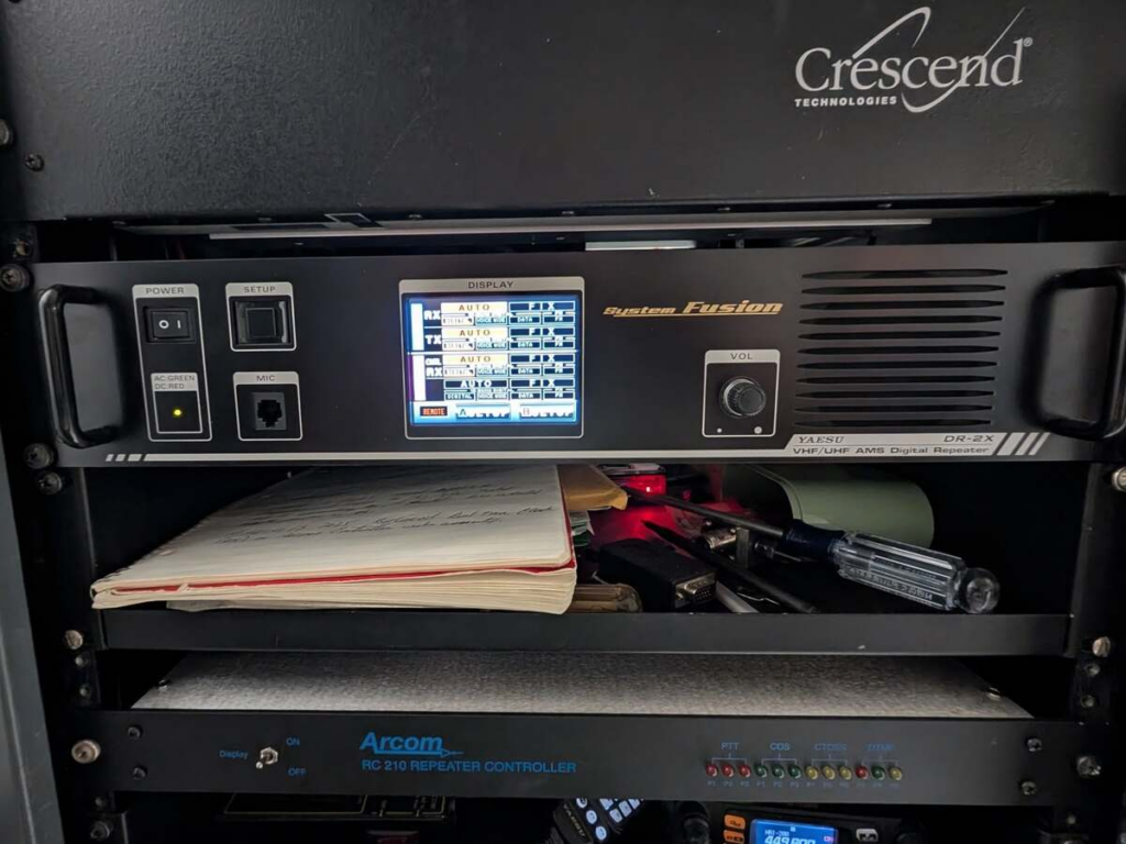 Front of the NY7S equipment rack containing the repeater, controller, linking radios, computers, network equipment, and power supplies.